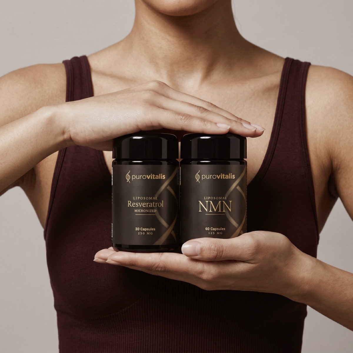 Hands holding PuroVitalis liposomal Resveratrol and NMN supplements